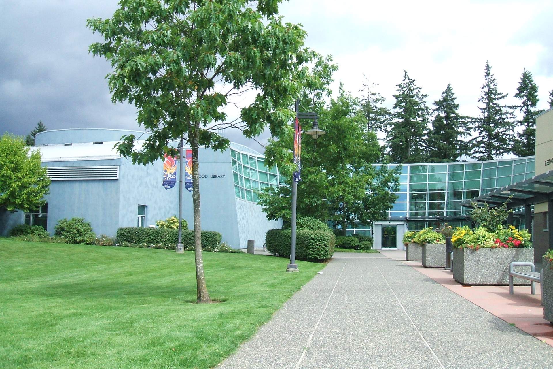 Fleetwood branch of Surrey Libraries on 84 Avenue, with a tree-lined walkway