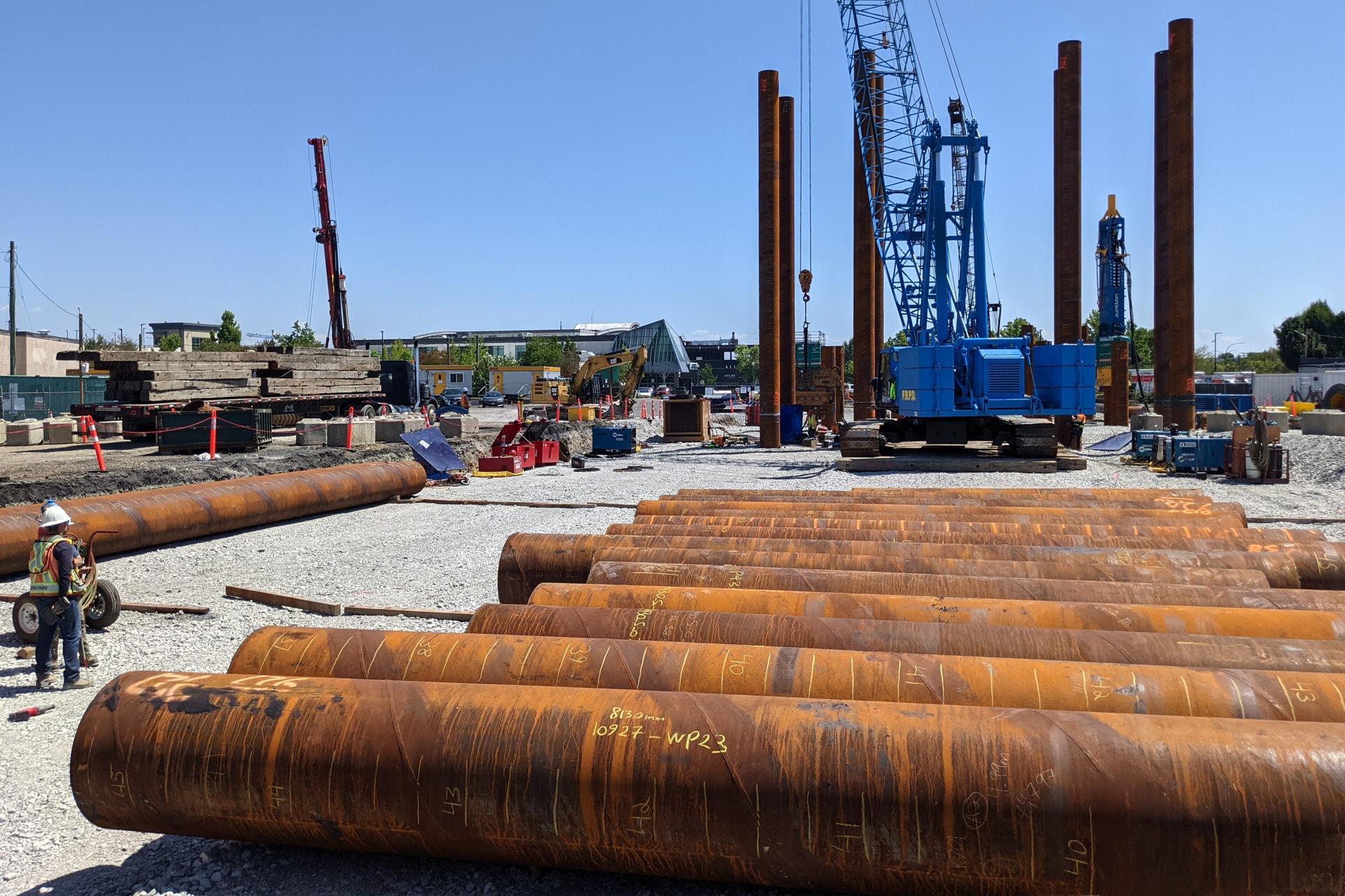 Piles and a drill rig at the Langley City Centre SkyTrain station construction site, July 2025