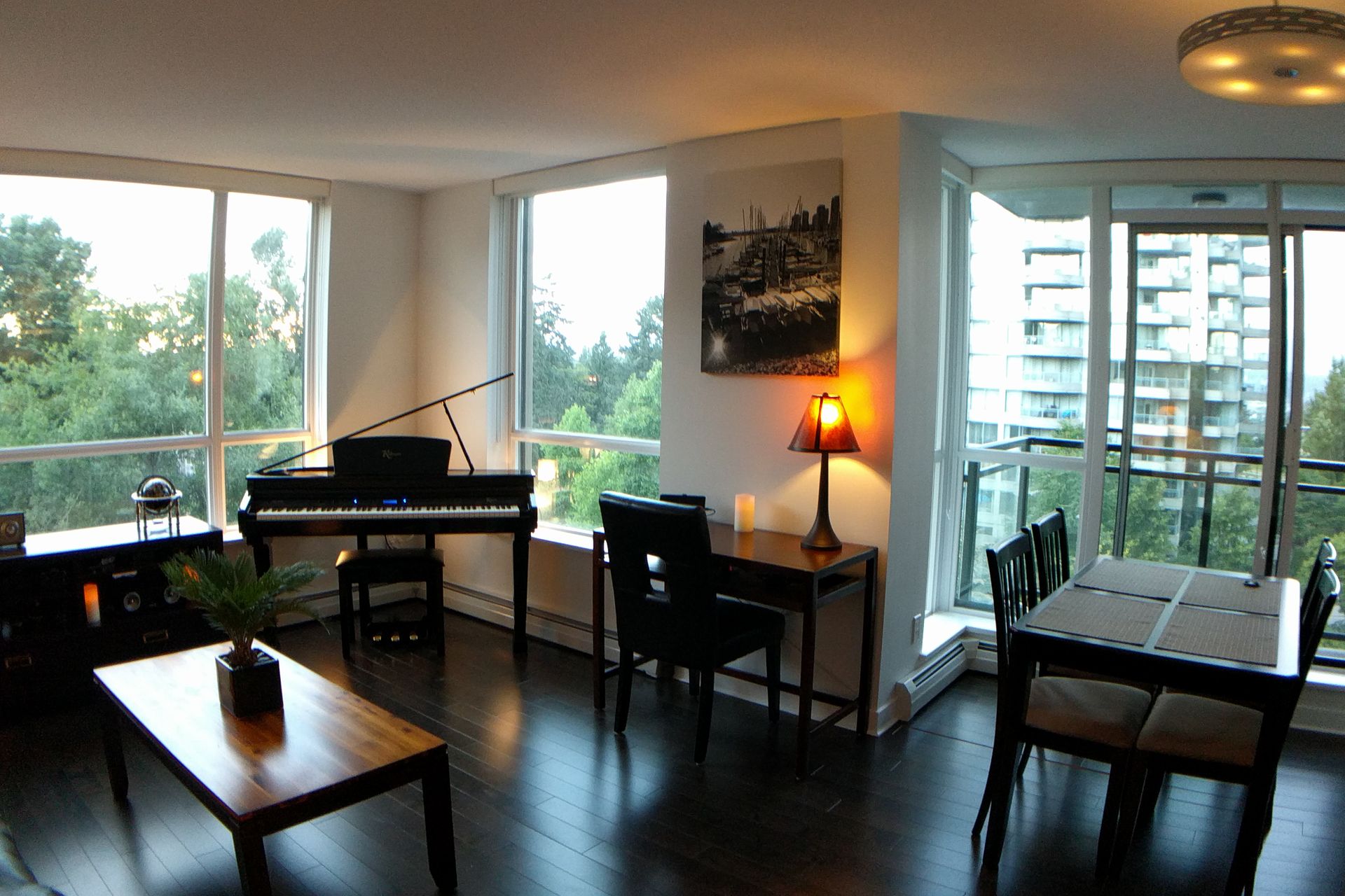 Living and dining area of a Surrey apartment with balcony windows
