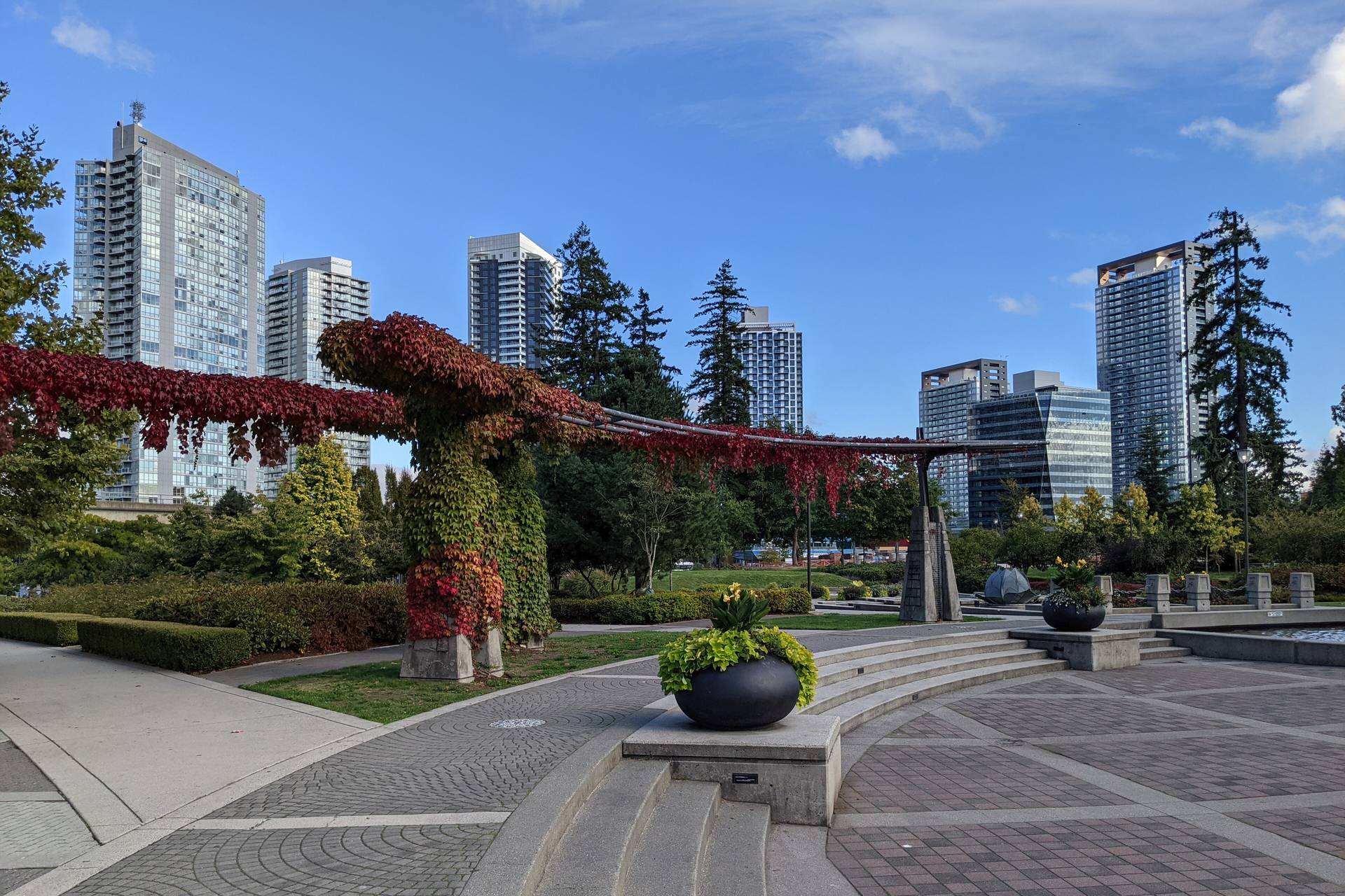 Holland Park plaza with Surrey City Centre high-rises behind the trees