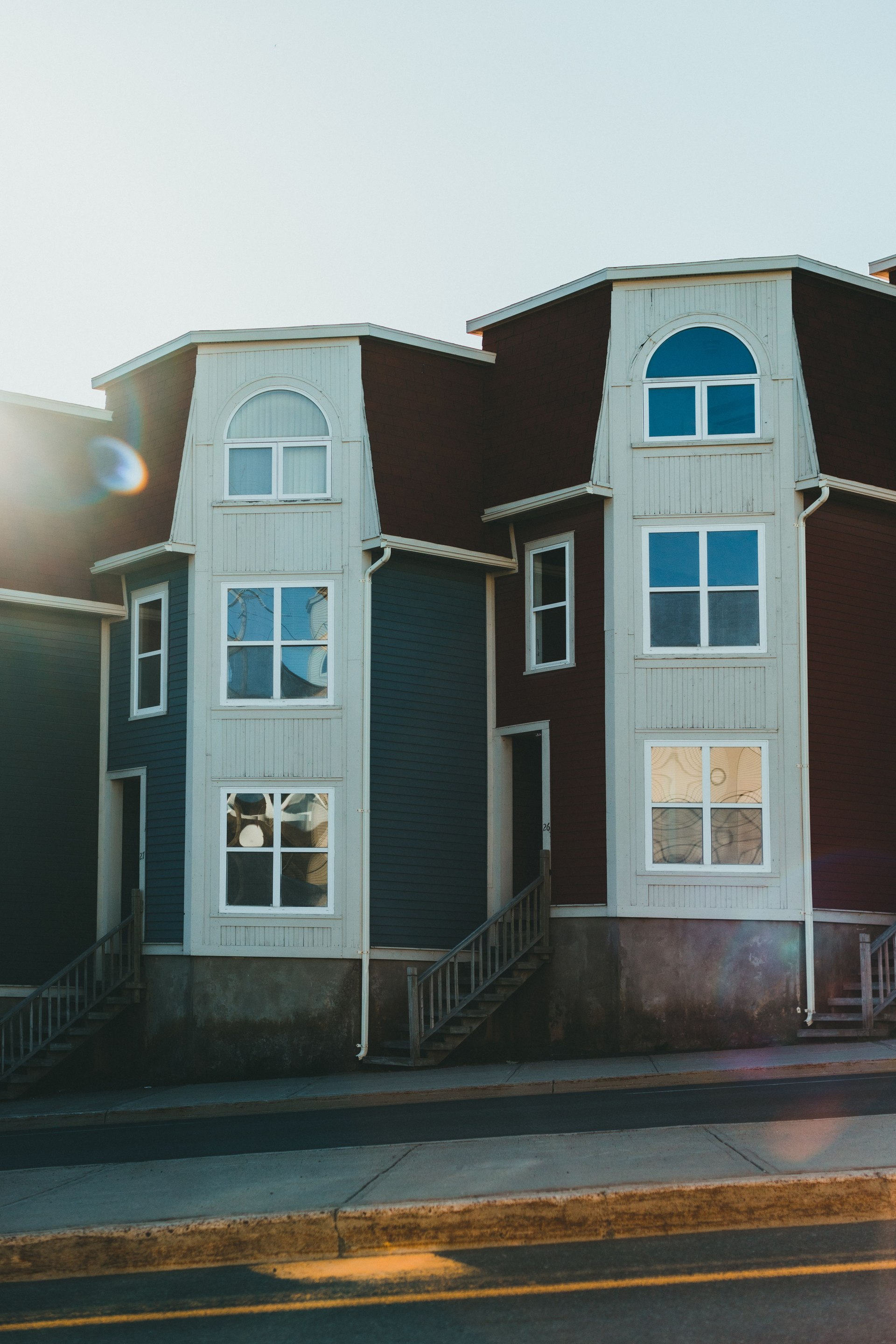 Townhouse facades with tall windows; location not verified